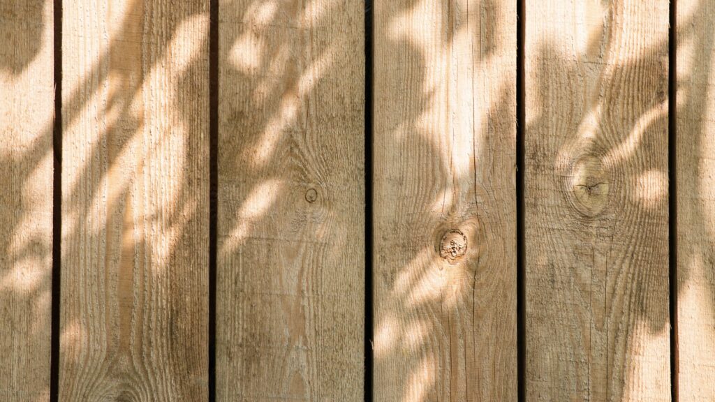Wooden privacy fence installed along a residential backyard by Henry Fence Co