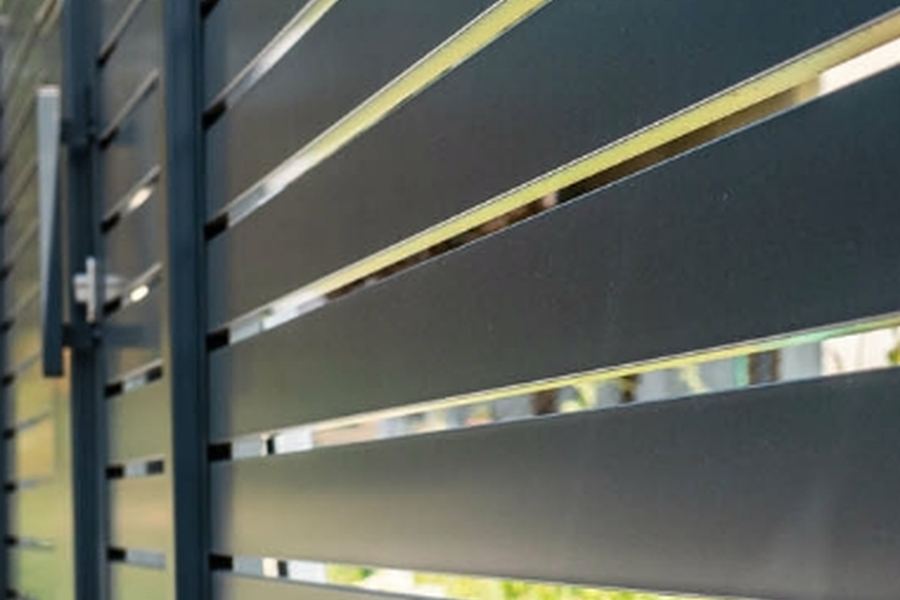 Horizontal composite fence panels in grey and black